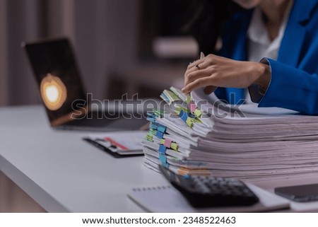 Asian business woman working late at night in office workplace. doing planning analyzing the financial report, business plan investment, finance analysis, Overtime work concept,  Royalty-Free Stock Photo #2348522463