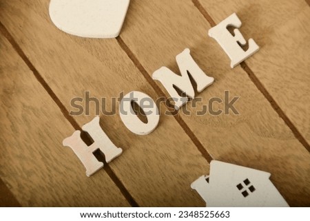 Sweet home sign. House wood with heart shape on wooden background
