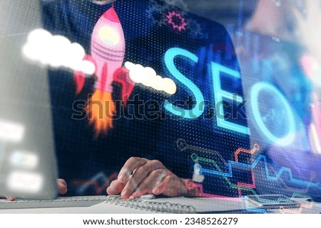 Multi exposure of seo icon with man working on computer on background. Concept of search engine optimization. Royalty-Free Stock Photo #2348526279