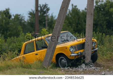 Broken bumper and hood of a car as a result of a collision with a pole, close-up. The car crashed into a lamp post. car accident Royalty-Free Stock Photo #2348536625
