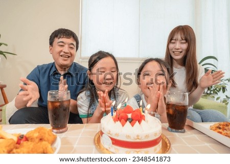 Young family with twins, birthday party image