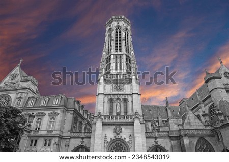 Great gothic church of Saint Germain l´Auxerrois (against the background of a sky at sunset), Paris, France