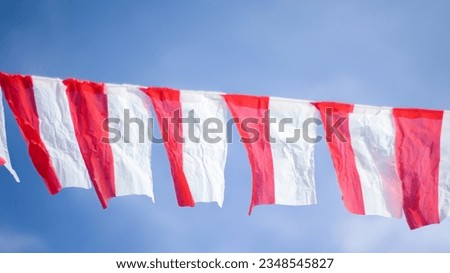 Indonesian red and white flag, hanging up with sky background