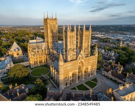 lincoln cathedral in beautiful evening golden light drone arial view unique perspective stunning west face yellow stone on top of steep hill majestic gothic architecture Royalty-Free Stock Photo #2348549485