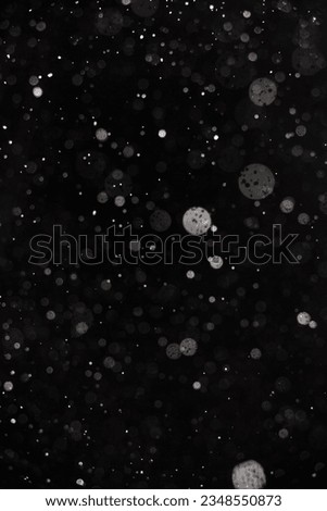 Abstract splashes of Rain and Snow Overlay Freeze motion of white particles on black background Royalty-Free Stock Photo #2348550873