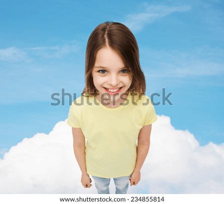 happiness, childhood and people concept - smiling little girl in blank t-shirt over blue sky and cloud background