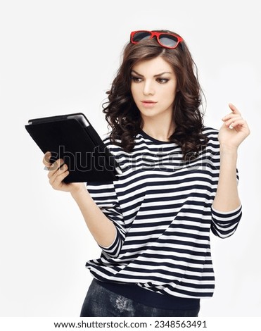 Young woman is using a tablet, reading and having fun