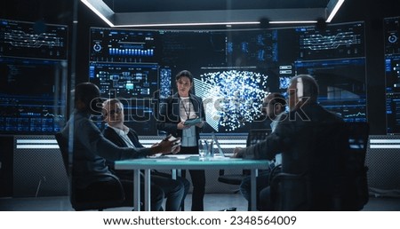 Chief Software Engineer Conducting a Quality Assessment Meeting With His Artificial Intelligence Design Team. Group of Developers Discussing Possible Development of a New Advanced Neural Network Royalty-Free Stock Photo #2348564009