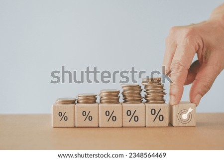 Financial concepts , financial investment business stock growth, profit, business strategy, business target or goal. hand hold   wooden cube block with dartboard icon  ,stack of coins on percentage