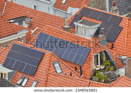 Solar panels attached to the roofs of ancient houses in the city center of Deventer, The Netherlands Royalty-Free Stock Photo #2348565801