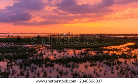 Aerial view of Mobile Bay and the downtown Mobile skyline at sunset on the Alabama Gulf Coast