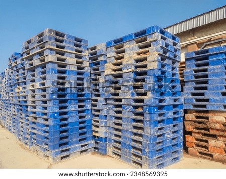 pile of dirty plastic pallets, concept photo of bankruptcy service cargo transportation industry service
