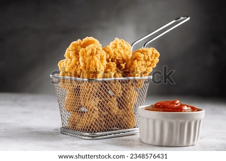 Breaded chicken strips. Chicken fingers. Royalty-Free Stock Photo #2348576431