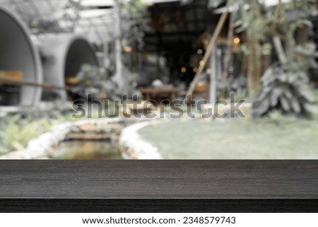 Empty wooden table with blurred background of cafe or coffee shop. For present products.
