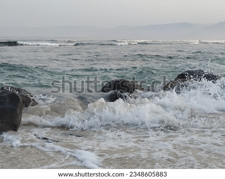 ocean waves crashing between the rocks