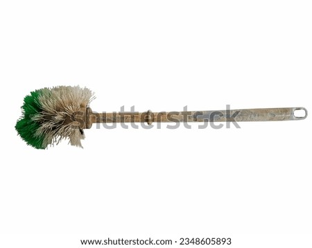 The worn toilet brush, a cleaning tool, shows signs of everyday housework in the bathroom.
