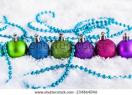 Christmas balls and garland on the snow 