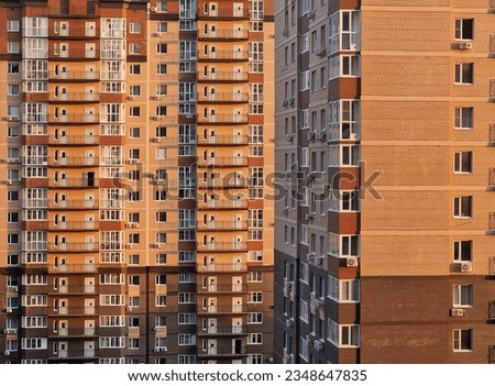 Multi-storey building in a modern residential complex, many windows, close-up photography in a minimalist style. Business buildings in metropolitan areas. Beautiful horizontal photo