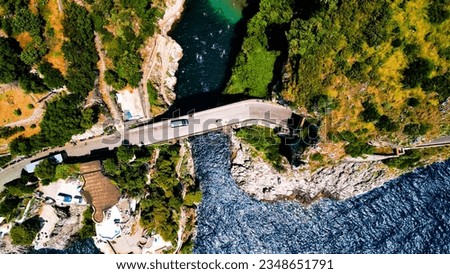Aerial view of famous fjord in Italy: Furore bridge in colorful landscape among cliffs and turquoise sea water