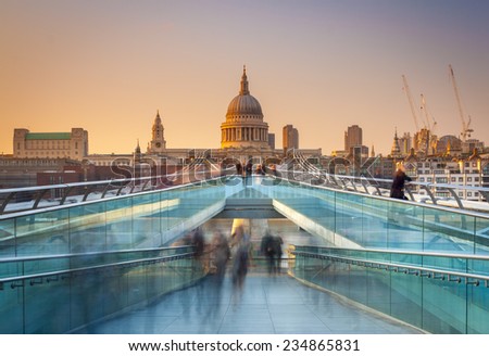 Blurred motion view over the Millennium footbridge looking towards St. Paul's Cathedral at sunset