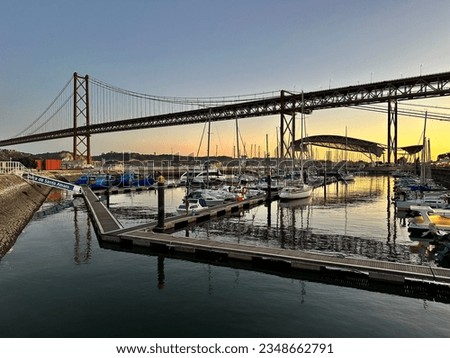 Dock near the Bridge in Lisbon in the evening. (Translation of the text "Doca de Santo Amaro": Dock of Saint Amaro)