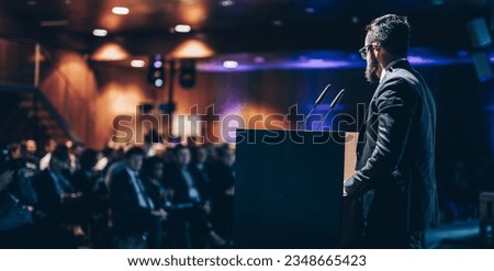 Speaker giving a talk on corporate business conference. Unrecognizable people in audience at conference hall. Business and Entrepreneurship event. Royalty-Free Stock Photo #2348665423