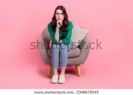 Full body photo of unsatisfied miserable lady sit chair hand touch chin look empty space isolated on pink color background Royalty-Free Stock Photo #2348678545