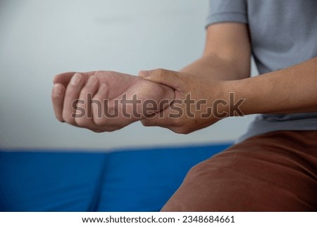 Close-up photo of a man with wrist pain health care concept