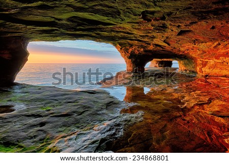 Beautiful sea cave sunset on Lake Superior near Munising, Michigan and Pictured Rocks National Lakeshore. Royalty-Free Stock Photo #234868801