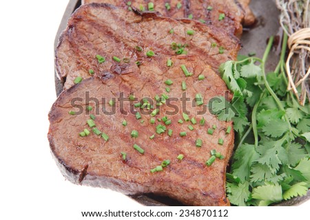 fresh grilled red meat with thyme on metal pan isolated on white background