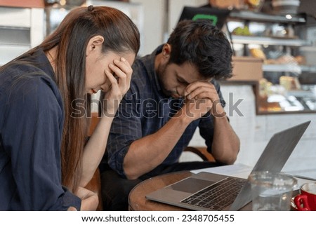 Stressed and headache asian couple with large bills or invoices no money to pay to expenses and business problem. shortage, Financial problems, mortgage, loan, bankruptcy, bankrupt, poor Royalty-Free Stock Photo #2348705455