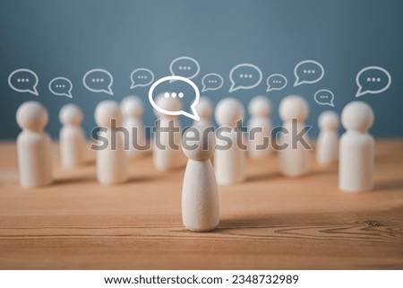 Wood figure with standing out from the crowd of different people, chatting concept, Wooden figurine with speech bubble, Unique human shape, Leadership,  Human resource. Royalty-Free Stock Photo #2348732989