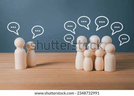 Wood figure with standing out from the crowd of different people, chatting concept, Wooden figurine with speech bubble, Unique human shape, Leadership,  Human resource. Royalty-Free Stock Photo #2348732991