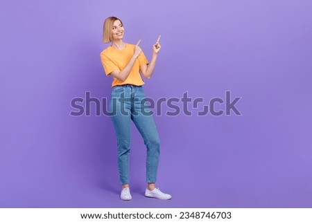 Full length photo of young promoter girl direct fingers empty space interesting news banner isolated purple color background