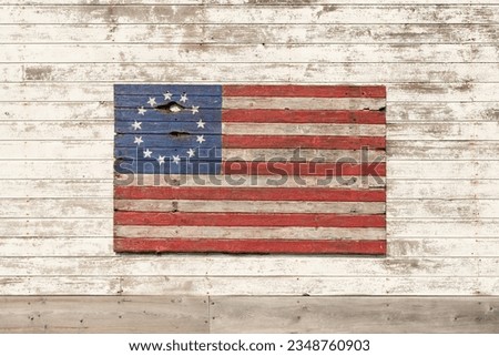 Painted wooden Colonial American Flag on old barn.  Franklin Grove, Illinois, USA.