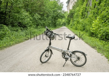 lightweight folding bike on Katy Trail near Rocheport, Missouri, summer scenery. The Katy Trail is 237 mile bike trail converted from an old railroad. Royalty-Free Stock Photo #2348764727