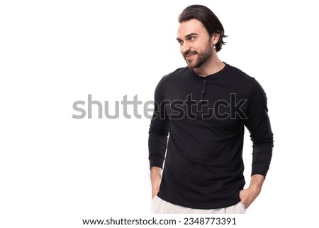 authentic brutal macho man with black hair and beard with an earring in his ear isolated on white background with copy space Royalty-Free Stock Photo #2348773391