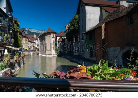 French Venice - Annecy pictures, Gothic buildings, streets with flowers, river passing from city center, lake near city, Alps mountains. city from medieval age to today from tales.