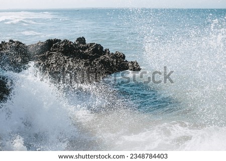 Big splashes of ocean waves on the rocks.