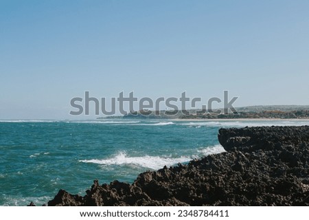 View of the beautiful shore and the blue waves of the ocean