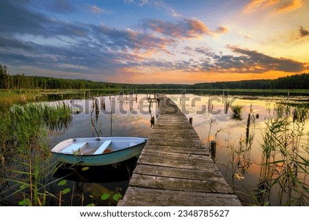 Beautiful summer sunset over the lake Royalty-Free Stock Photo #2348785627