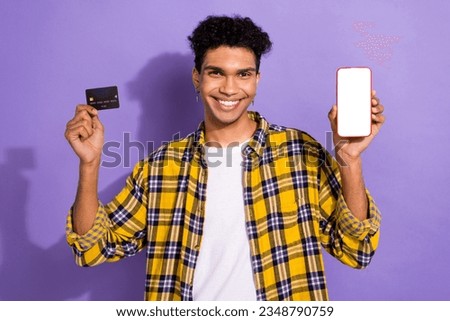 Photo of cool funky guy dressed checkered yellow shirt online shopping modern gadget empty space isolated purple color background