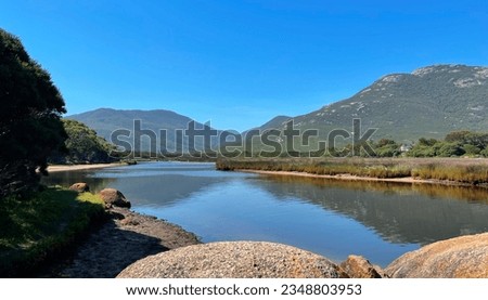 Tidal River Landscape, Melbourne Australia. View of still water and rocks with blue sky. Wilsons Prom National Park Royalty-Free Stock Photo #2348803953