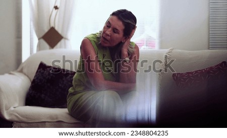Neurotic older woman sitting at home couch struggling with preoccupation and ruminations, anxious lady Royalty-Free Stock Photo #2348804235