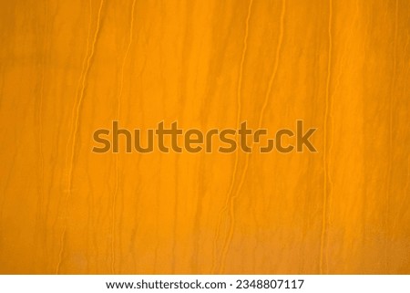 a rusty orange brown metal plate with line pattern 