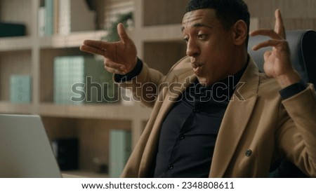 Shocked surprised happy male businessman African american man astonish wonder win online victory on laptop business good offer celebrate internet opportunity achievement excited guy dancing in office Royalty-Free Stock Photo #2348808611