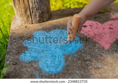 Toddler girl playing with crayons on porch