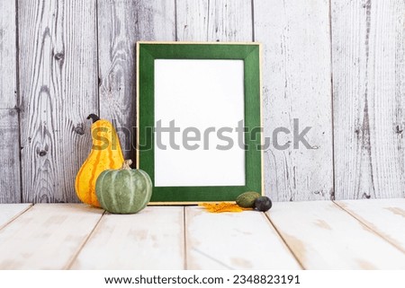 Picture frame mockup in cozy home interior with fall decor, pumpkin and leaves. Autumn, Thanksgiving, Halloween concept.