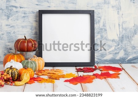 Picture frame mockup in cozy home interior with fall decor, pumpkin and leaves. Autumn, Thanksgiving, Halloween concept.