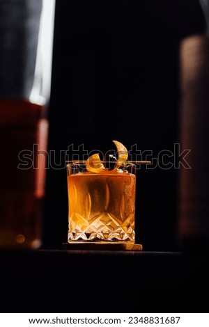 Alcoholic Old Fashioned Cocktail classic on the rocks garnish with orange peel and a cherry Royalty-Free Stock Photo #2348831687